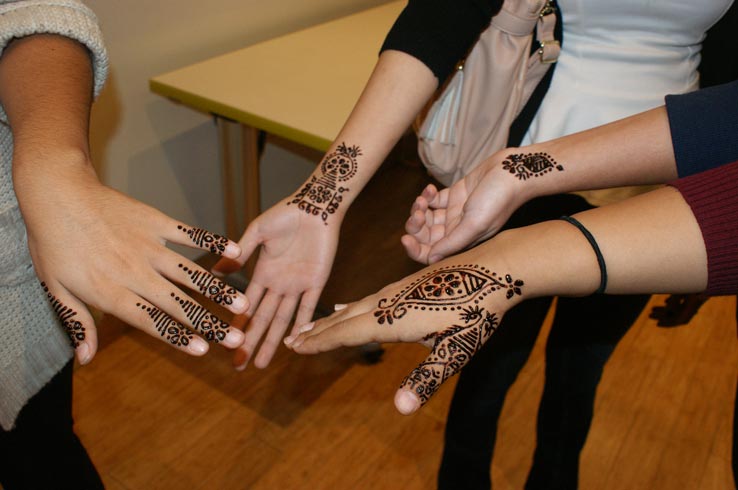 Four hands with decorations drawn on them.